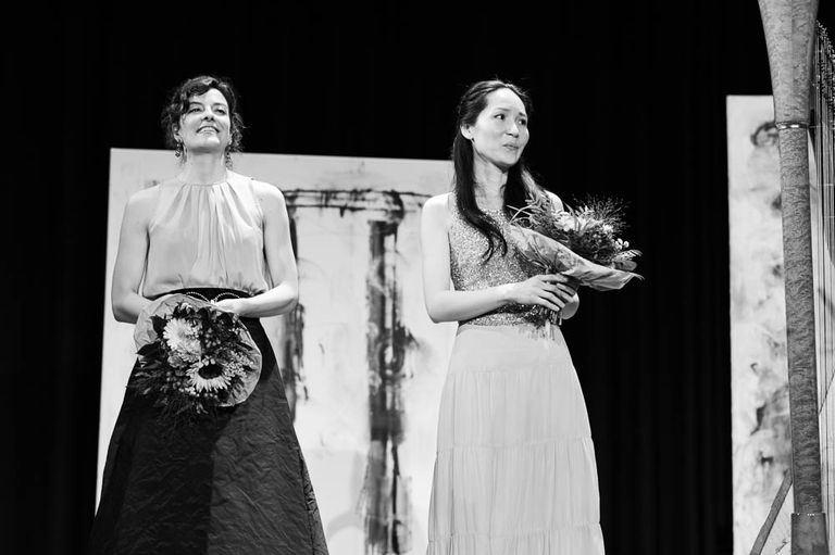 The interpreters after a performance of “Songs in Pictures”. Both women are holding a nosegay